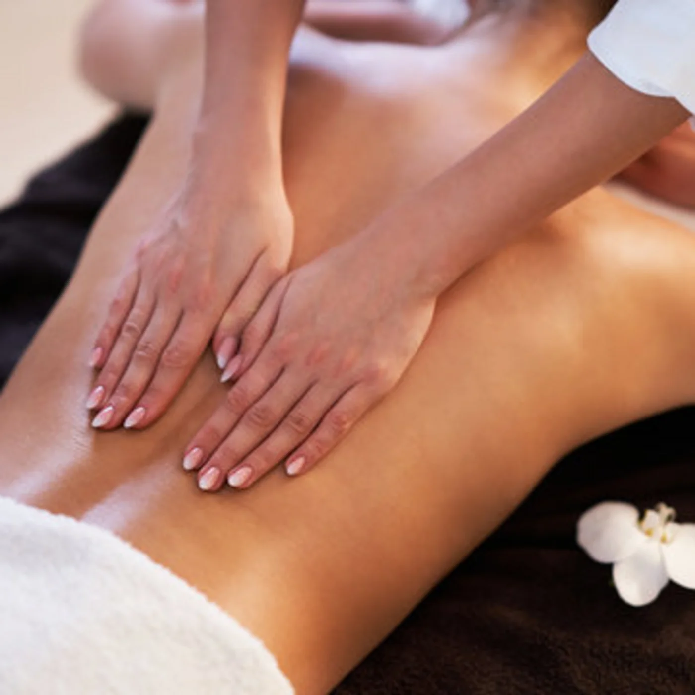 The modern AlpSpa at your spa hotel in Tyrol Back massage with both hands on a spa treatment table