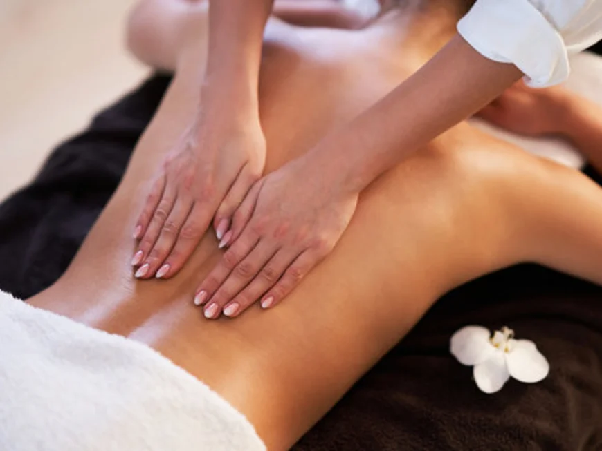 The modern AlpSpa at your spa hotel in Tyrol Back massage with both hands on a spa treatment table