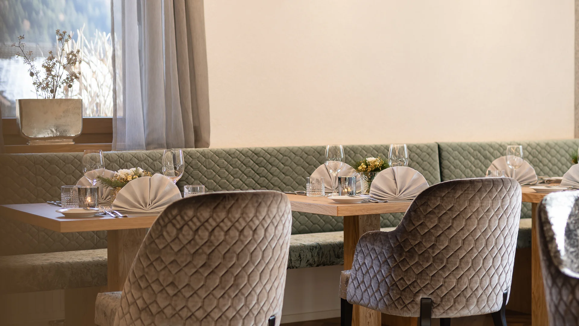 Elegantly set tables and upholstered chairs in a restaurant