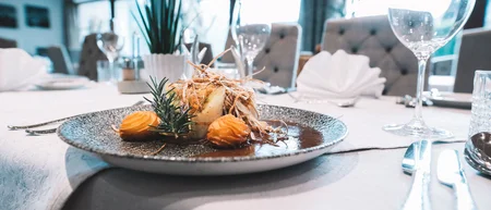 Set restaurant table with an artfully arranged gourmet dish