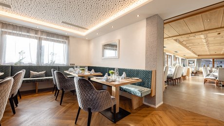 An inside look at our hotel in Stubaital in Fulpmes Cozy restaurant area with modern chairs and wooden flooring