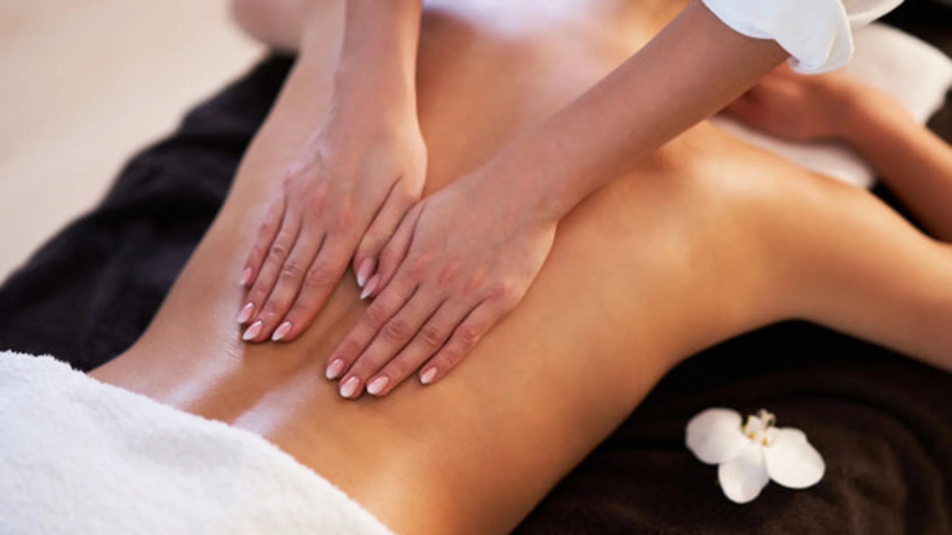 Back massage using hands in a spa setting