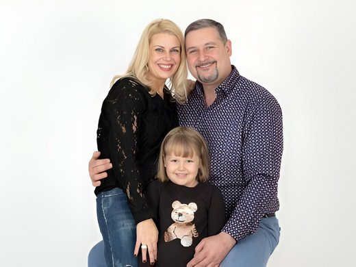 My hotel in Fulpmes in Stubaital Happy family with mother, father, and daughter posing against white background