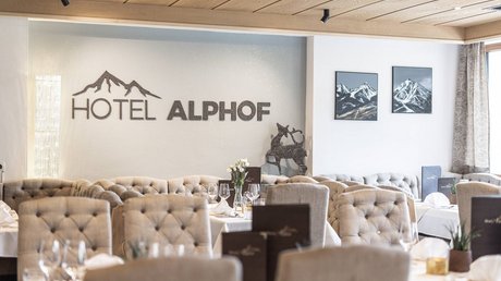 Einblicke in unser Hotel im Stubaital in Fulpmes Elegantes Restaurant im Hotel Alphof mit Bergbildern und bequemen Polsterstühlen