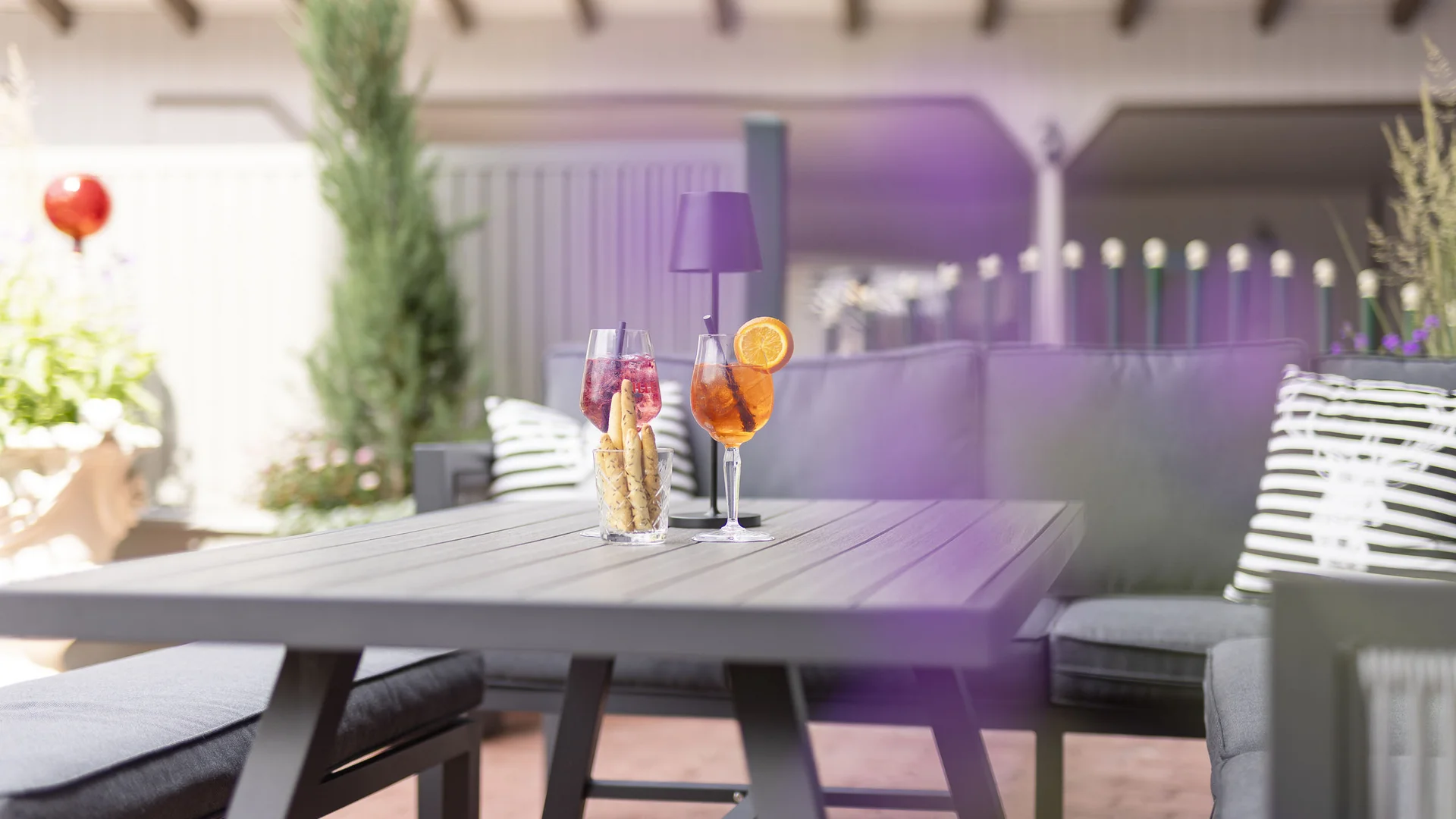 Sunny terrace with a table, drinks and seating