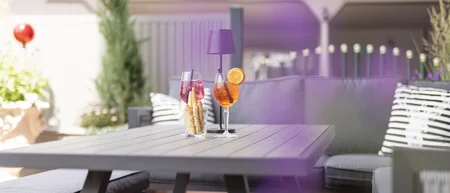 Sunny terrace with a table, drinks and seating