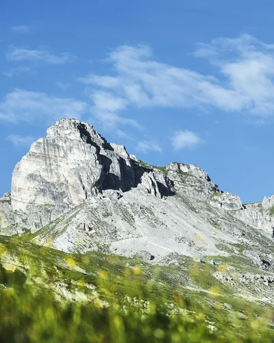 Hotel Alphof | your basecamp for walking holidays in Austria Gray rocky mountain peak beneath a blue sky with clouds