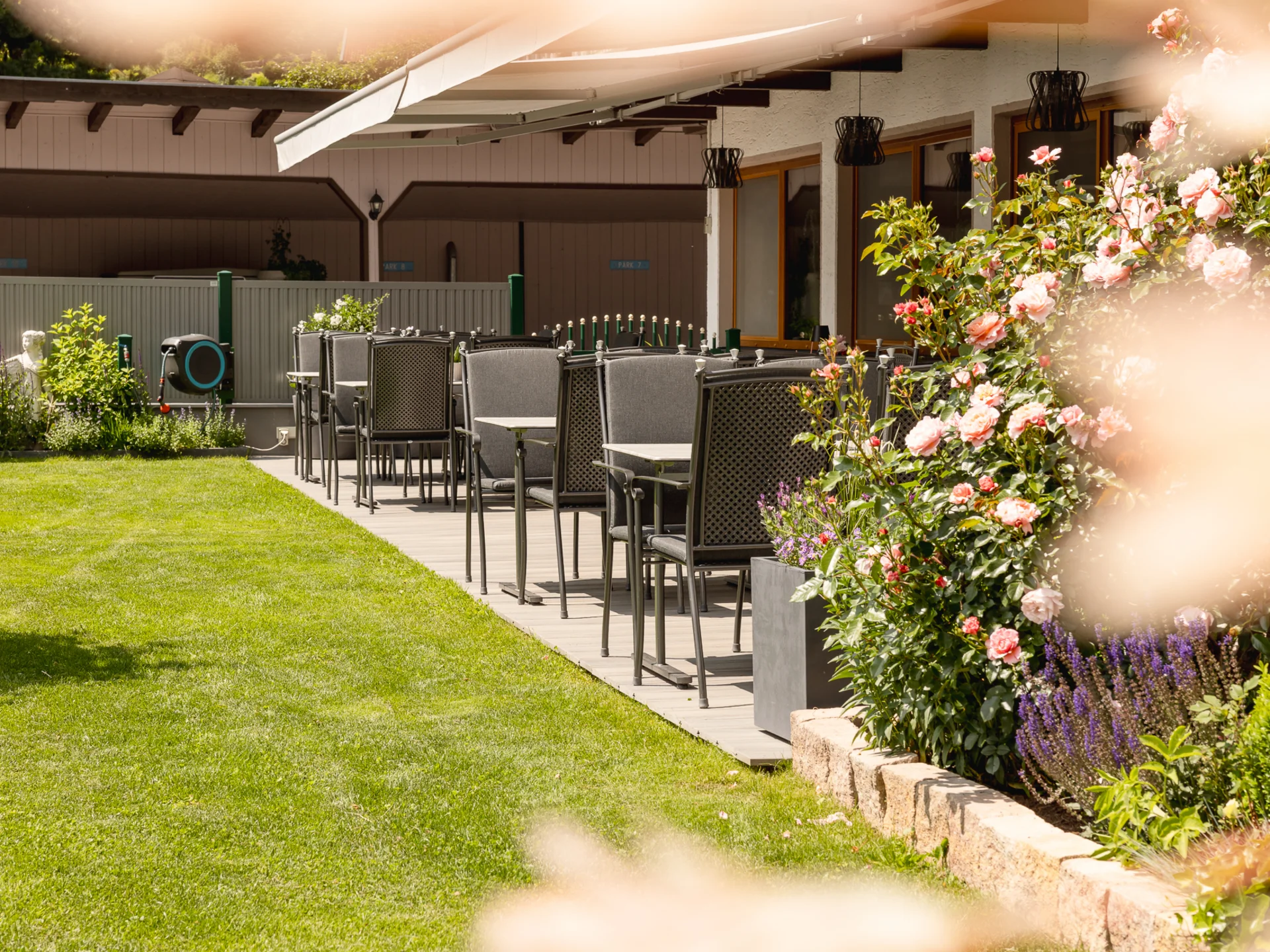 Garden and terrace at Hotel Alphof in Fulpmes, Tyrol Sunny garden terrace with seating and blooming roses