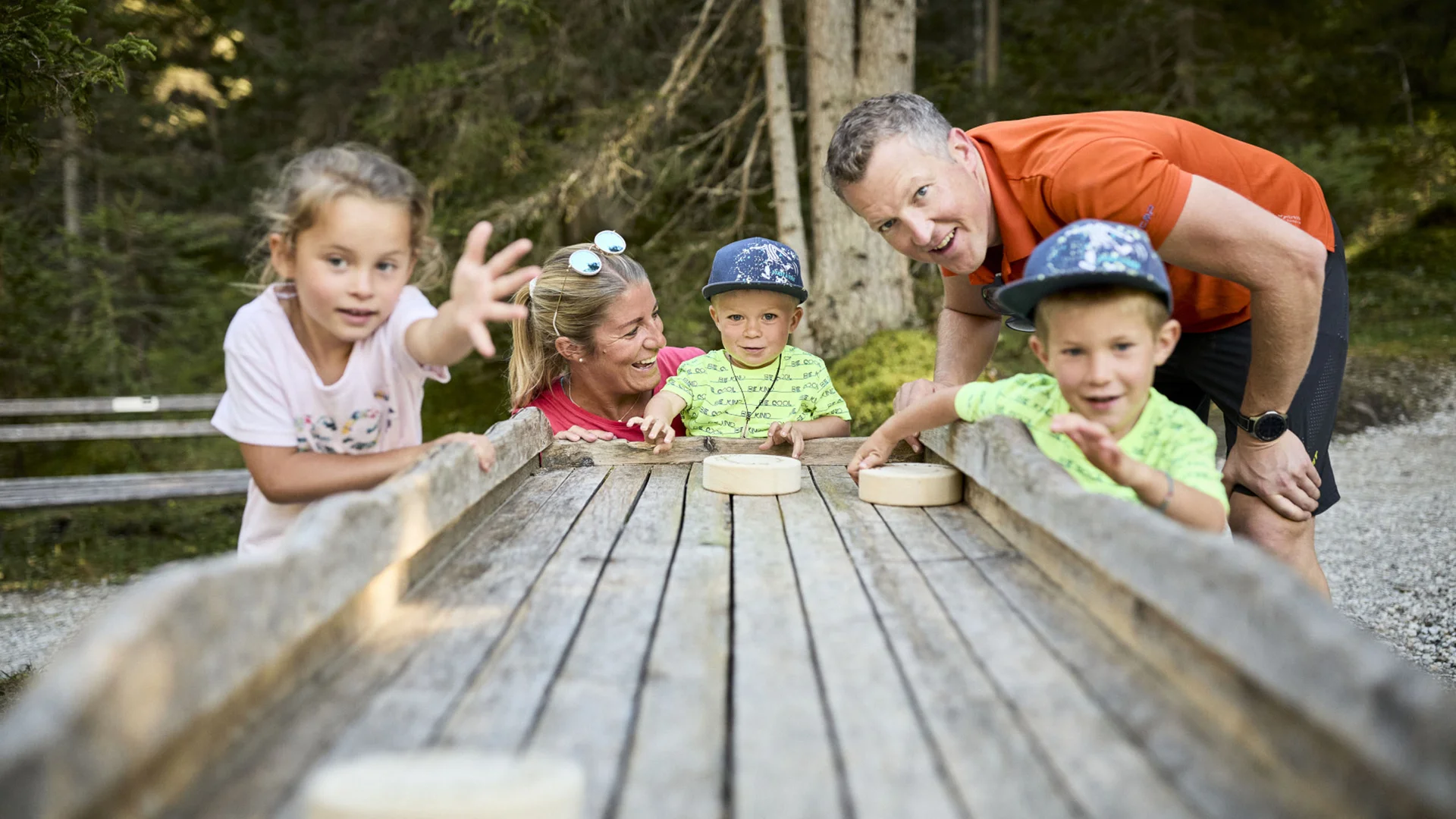 Family playing a wooden game in the forest
