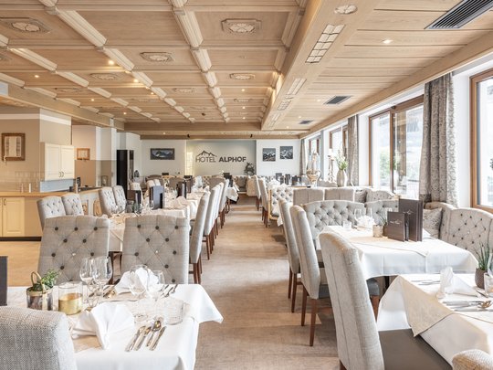 My hotel in Fulpmes in Stubaital Elegant restaurant with light upholstered chairs and wooden ceiling in Hotel Alphof