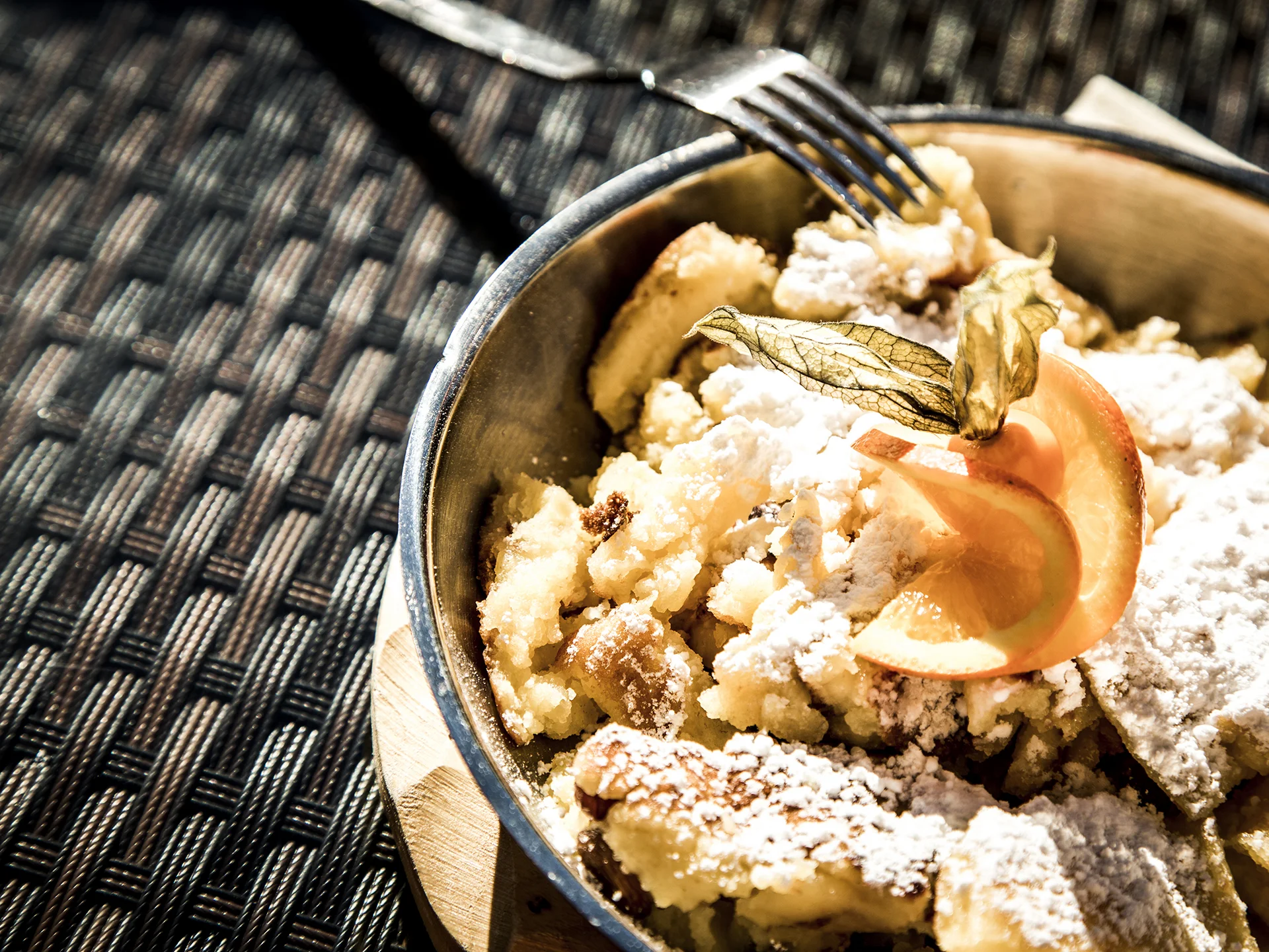 Alphof | genuine indulgence at a gourmet hotel in Tyrol Powdered sugar-dusted dessert with an orange slice in a bowl