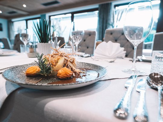 My hotel in Fulpmes in Stubaital Gourmet dish artfully plated on a gray plate at a fine dining table